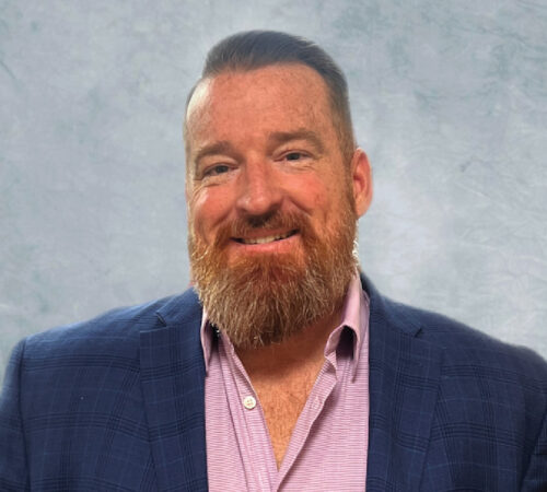 Headshot photo of Jay Heenan smiling