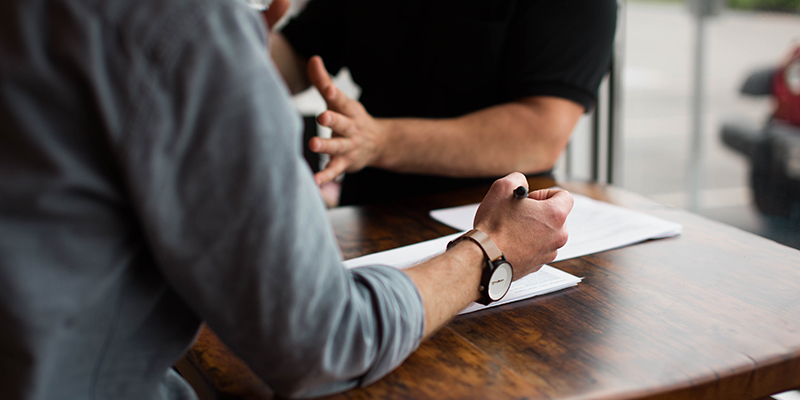 conversation at table with papers