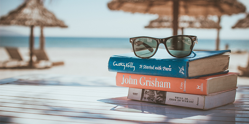 Tropical Setting with books and sunglasses