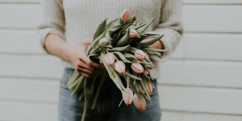 Holding a bouquet of tulips